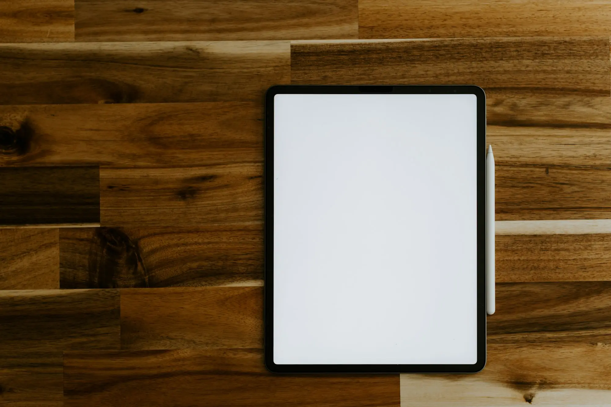 Tablet lying on a timber desk ready for an electronic signature